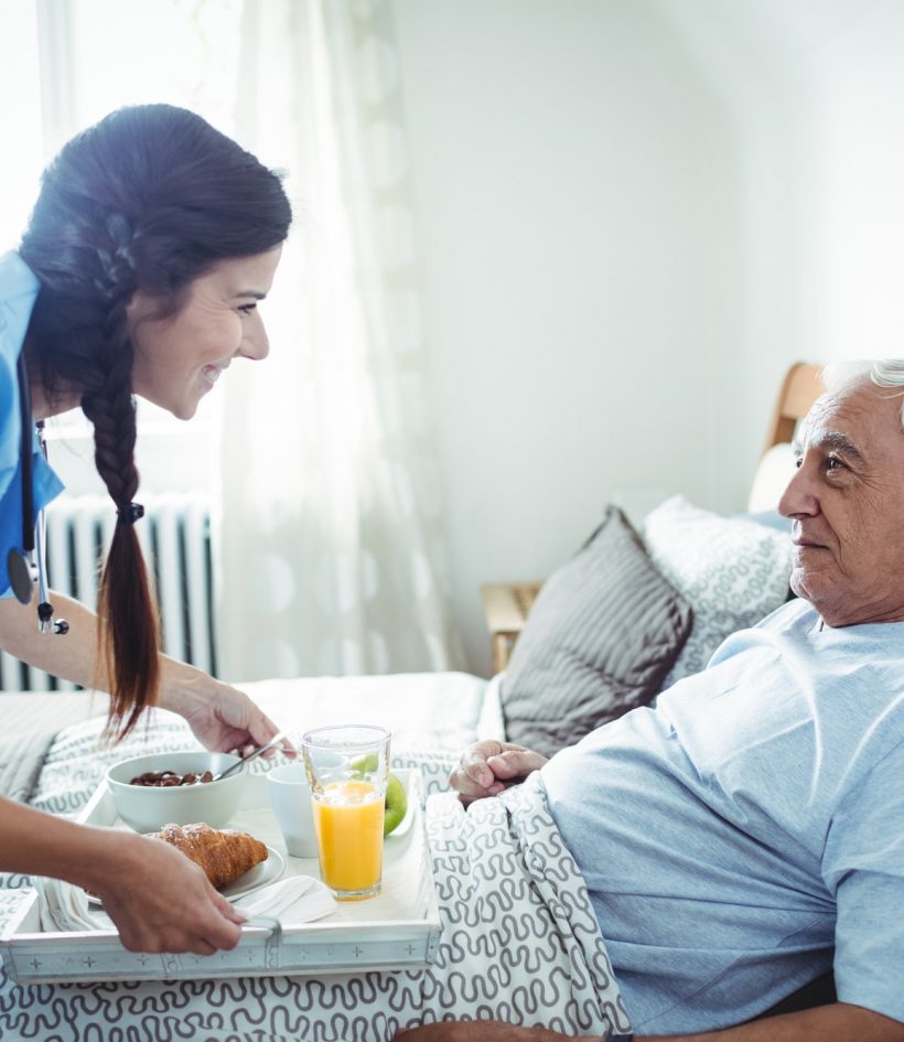nurse-serving-breakfast-to-senior-man.jpg