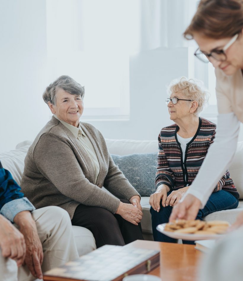 volunteer-helps-seniors-living-in-a-care-home-for-elderly.jpg